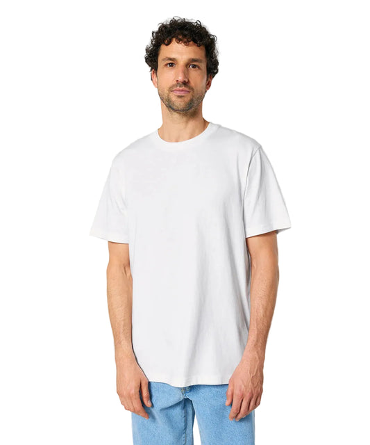 Man wearing a plain white t-shirt and light blue jeans against a gray background